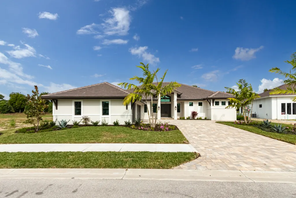 Exterior front wide street at The Heron House, a custom home built by Marvin Homes in Naples, Florida