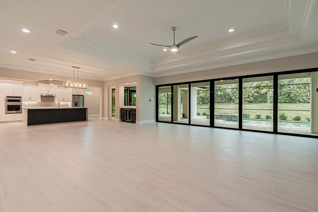 Great room open kitchen at The Heron House, a custom home built by Marvin Homes in Naples, Florida