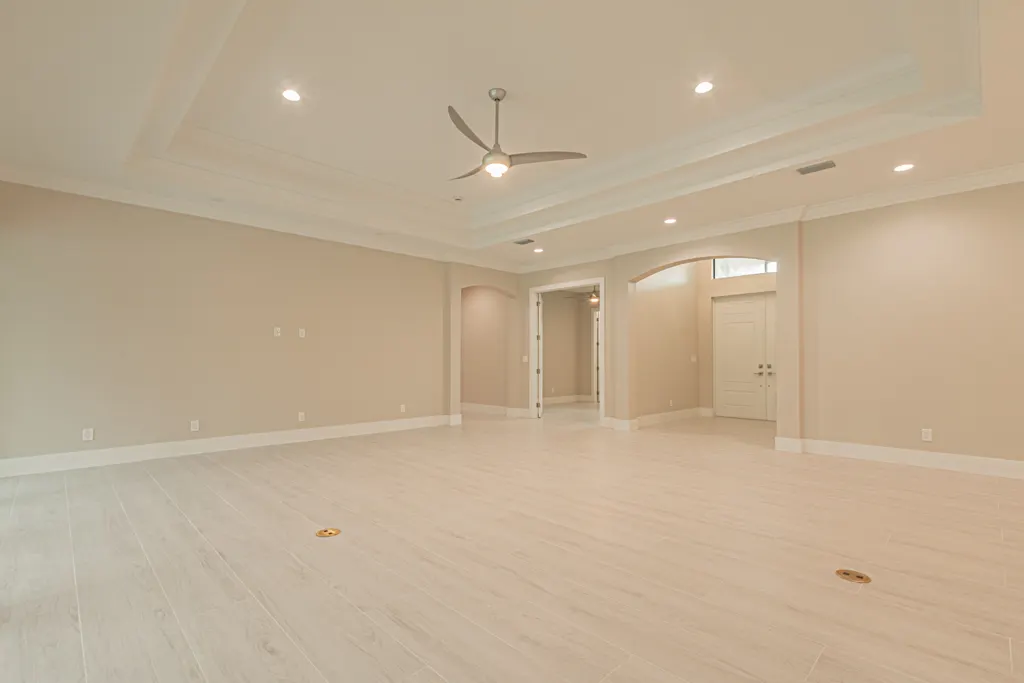 Great room toward foyer at The Heron House, a custom home built by Marvin Homes in Naples, Florida