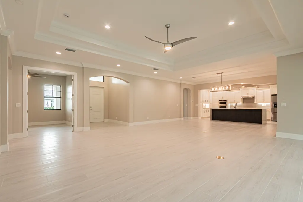 Great room toward kitchen at The Heron House, a custom home built by Marvin Homes in Naples, Florida