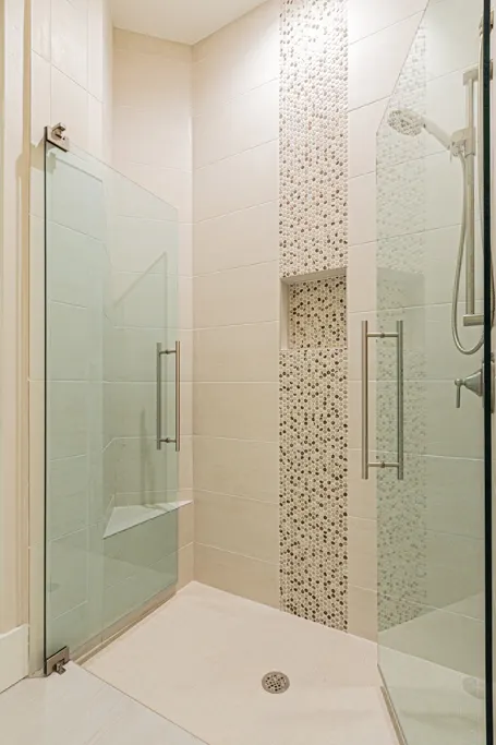 Guest bathroom shower at The Heron House, a custom home built by Marvin Homes in Naples, Florida