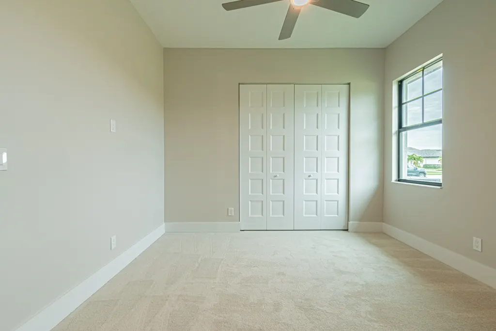 Guest bedroom at The Heron House, a custom home built by Marvin Homes in Naples, Florida