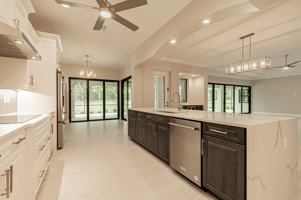 Kitchen view to lanai at The Heron House, a custom home built by Marvin Homes in Naples, Florida