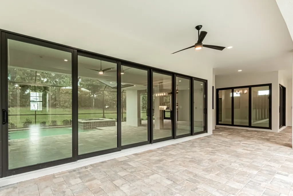 Lanai doors close at The Heron House, a custom home built by Marvin Homes in Naples, Florida