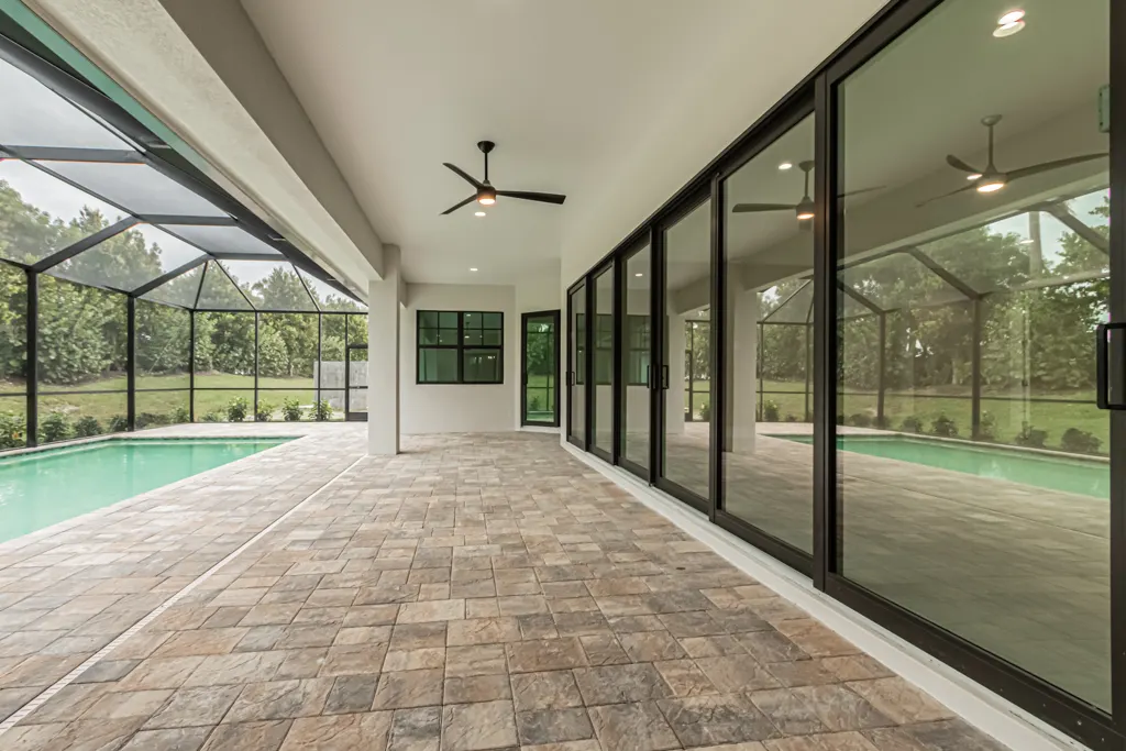 Lanai pool side at The Heron House, a custom home built by Marvin Homes in Naples, Florida