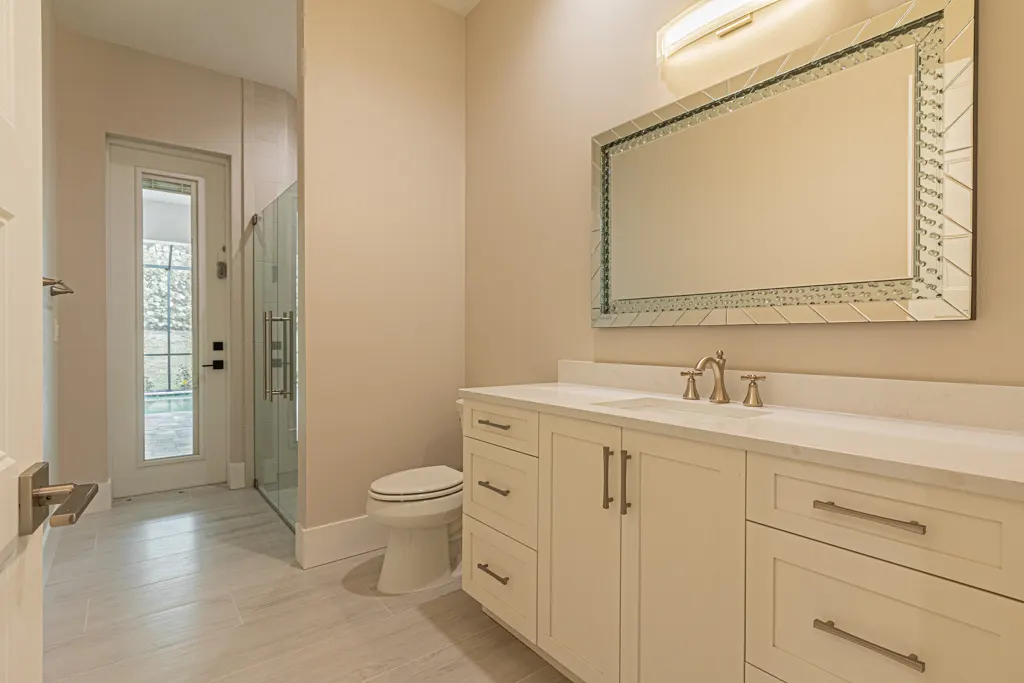Pool bathroom at The Heron House, a custom home built by Marvin Homes in Naples, Florida
