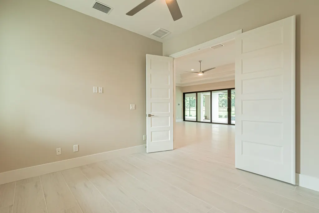 Primary bedroom at The Heron House, a custom home built by Marvin Homes in Naples, Florida