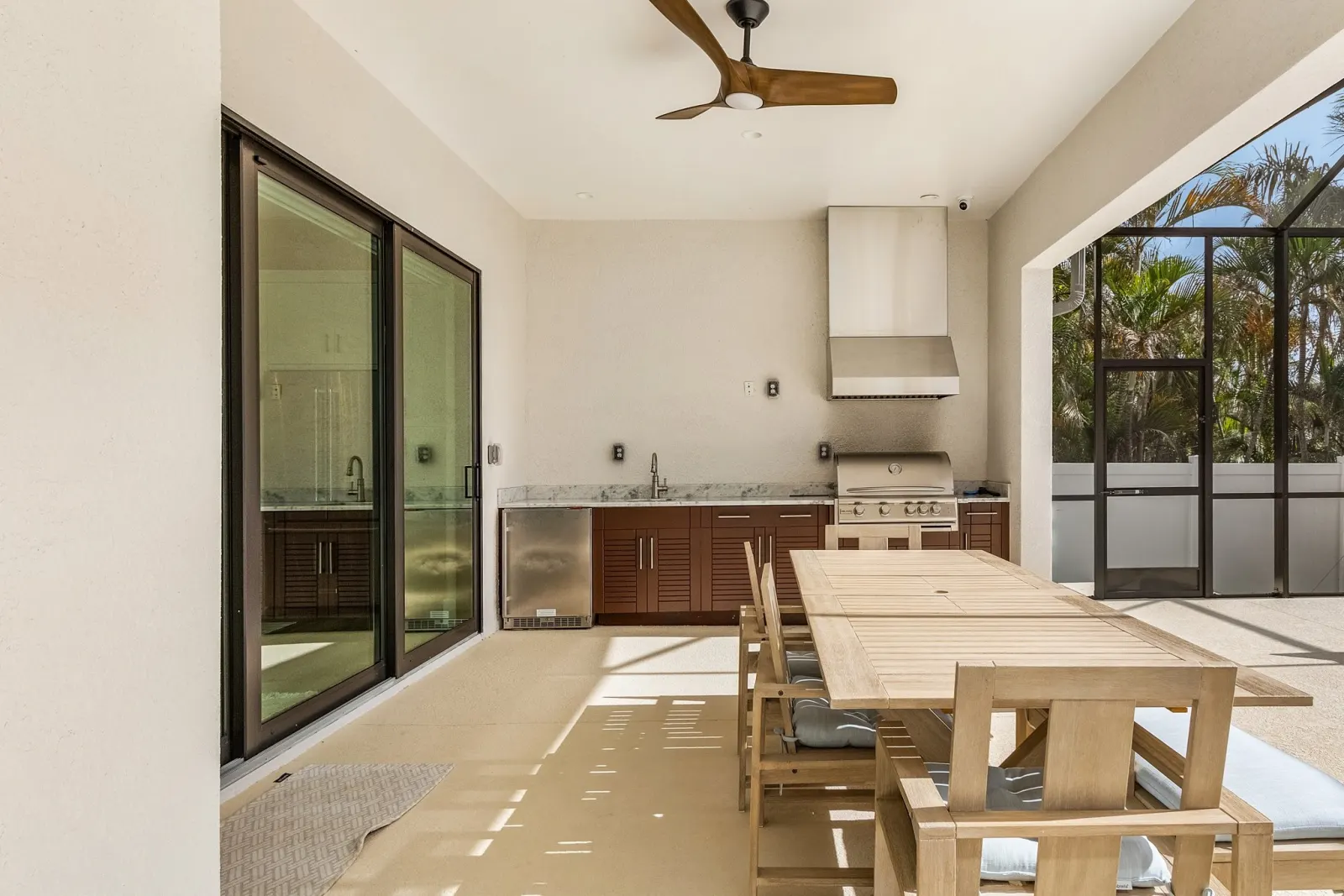 Outdoor kitchen dining at The Ibis, a custom home built by Marvin Homes in Cape Coral, Florida