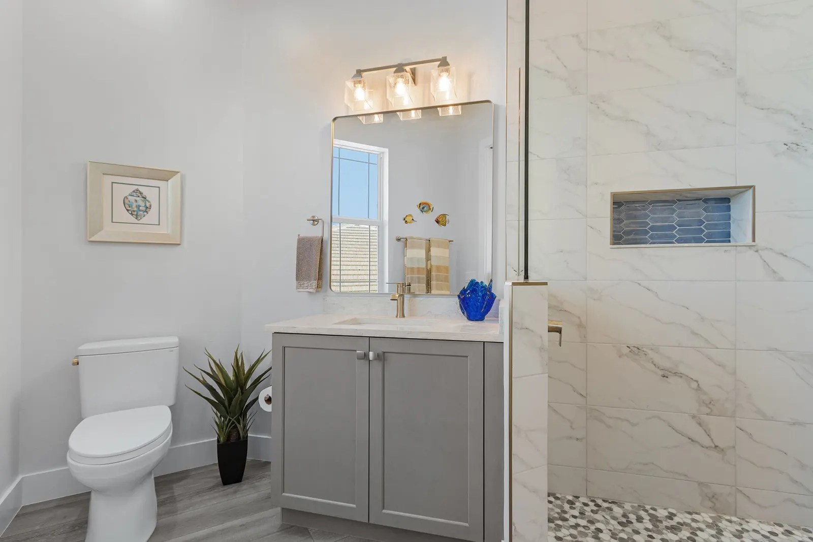 Bathroom guest shower niche at The Marlin, a custom home built by Marvin Homes in Cape Coral, Florida