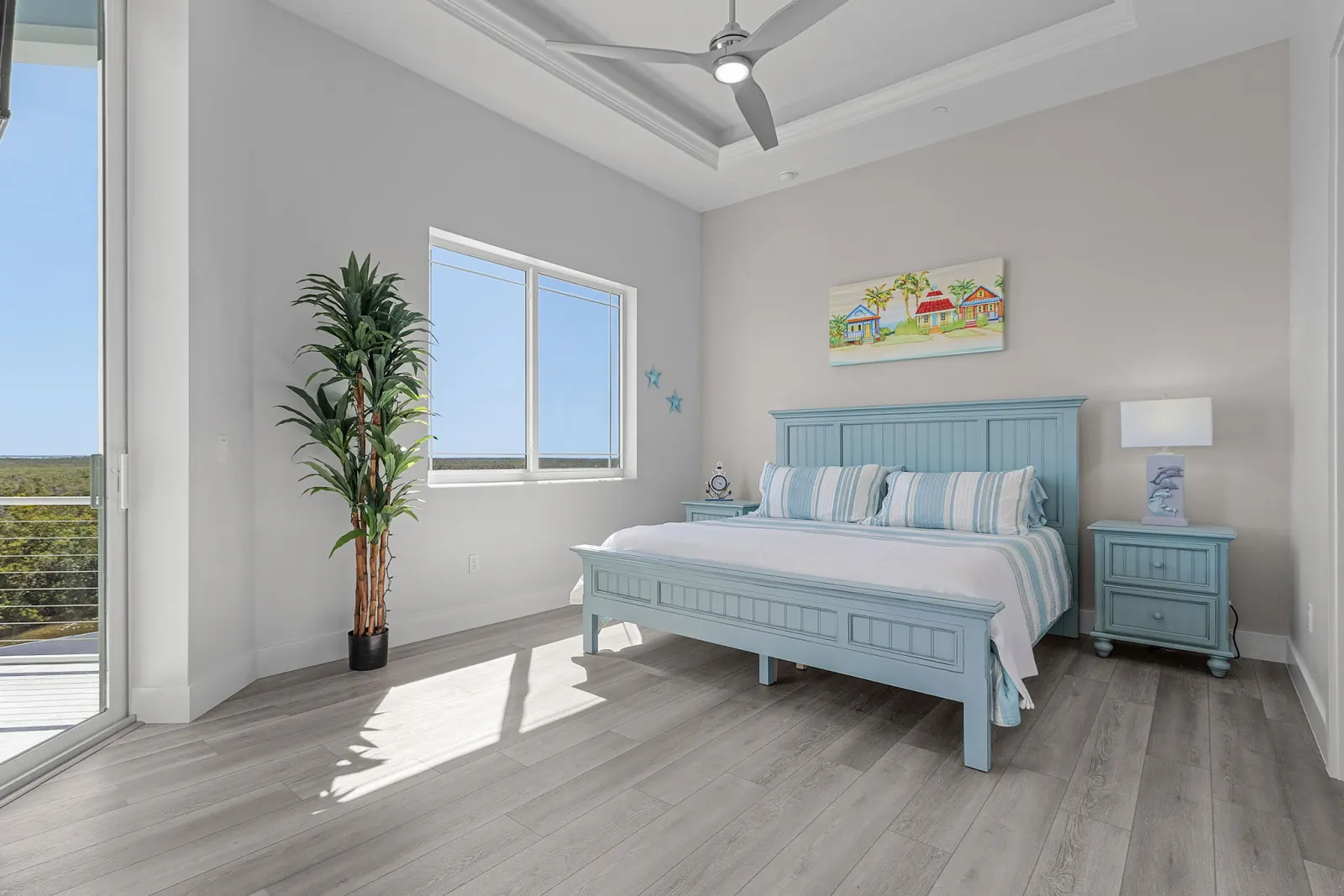 Bedroom blue headboard at The Marlin, a custom home built by Marvin Homes in Cape Coral, Florida