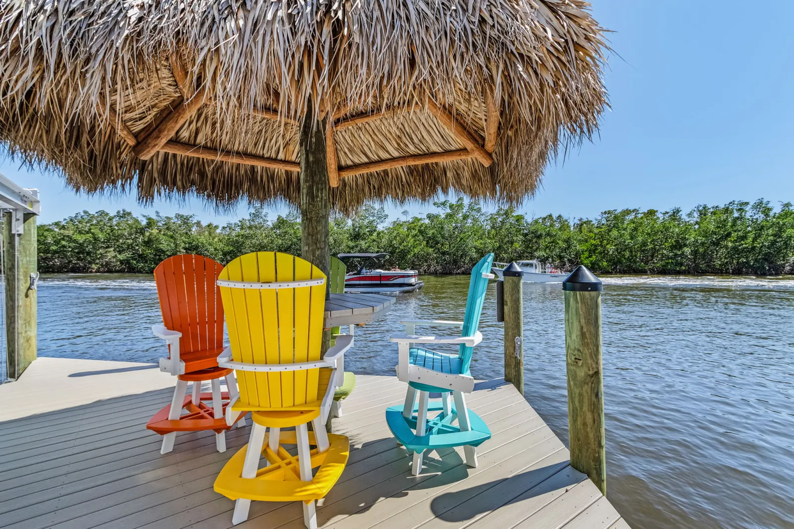 Dock tiki hut seating at The Marlin, a custom home built by Marvin Homes in Cape Coral, Florida