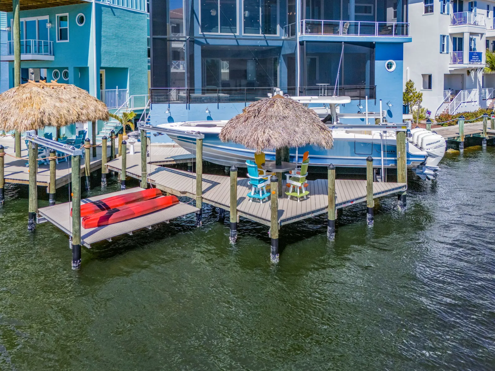 Dock tiki huts boat at The Marlin, a custom home built by Marvin Homes in Cape Coral, Florida