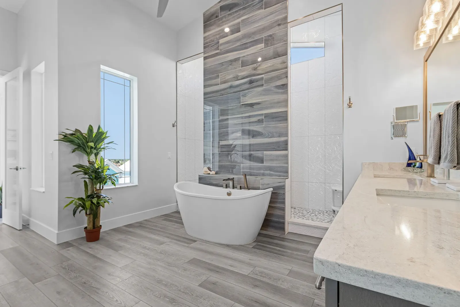 Master bathroom tub shower wide at The Marlin, a custom home built by Marvin Homes in Cape Coral, Florida