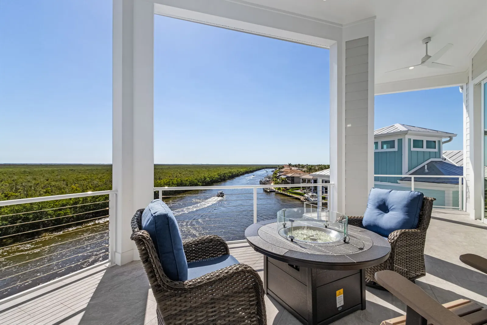 Rooftop deck firepit canal view at The Marlin, a custom home built by Marvin Homes in Cape Coral, Florida