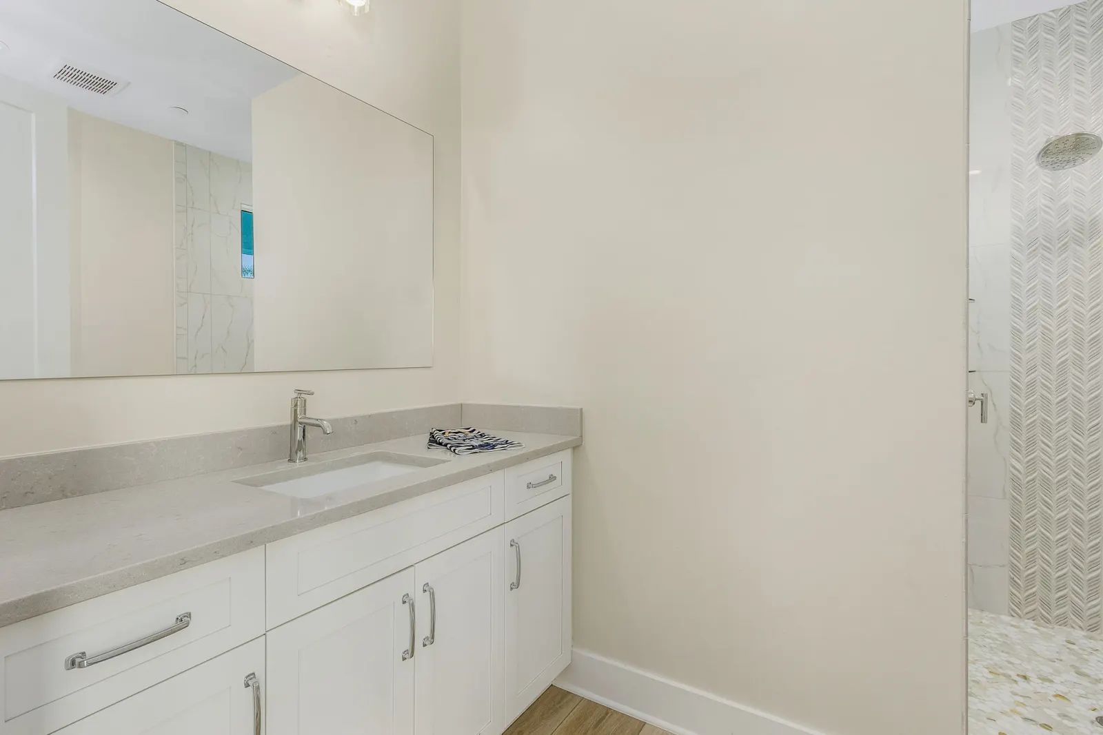 Bathroom chevron tile shower at The Octopus, a custom home built by Marvin Homes in Cape Coral, Florida
