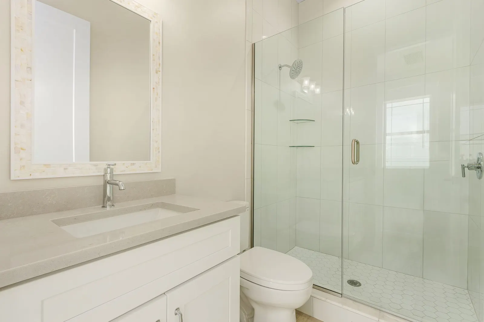 Bathroom guest mosaic mirror at The Octopus, a custom home built by Marvin Homes in Cape Coral, Florida