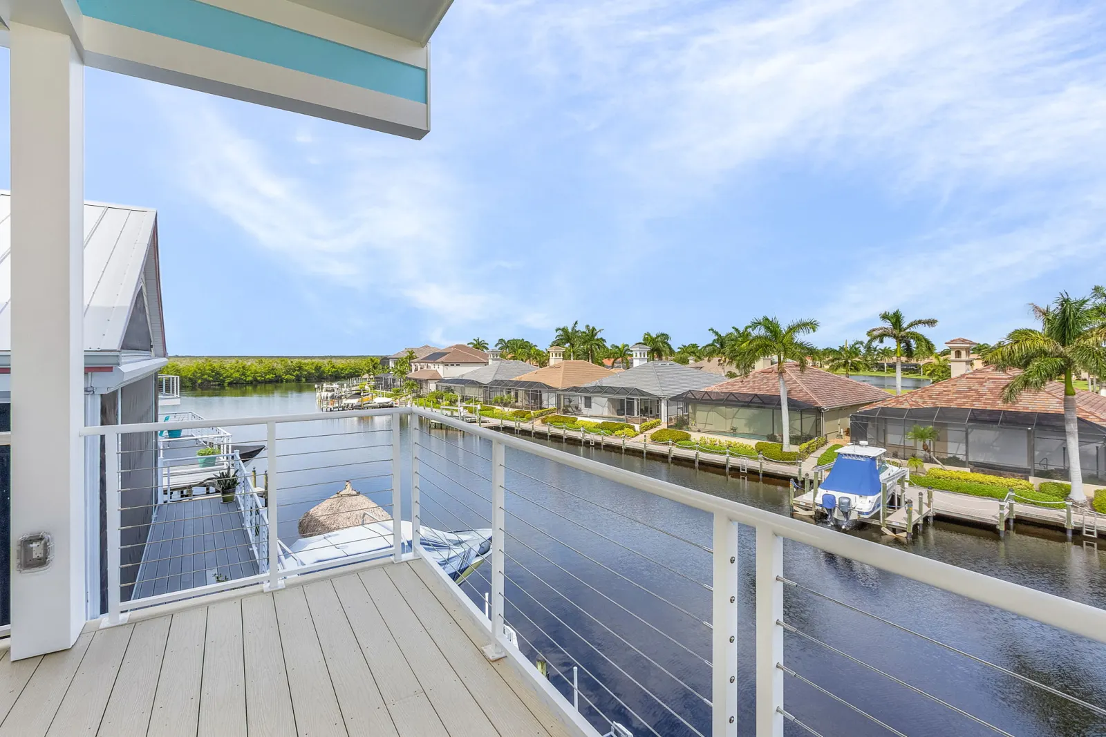 Deck view canal boats at The Octopus, a custom home built by Marvin Homes in Cape Coral, Florida