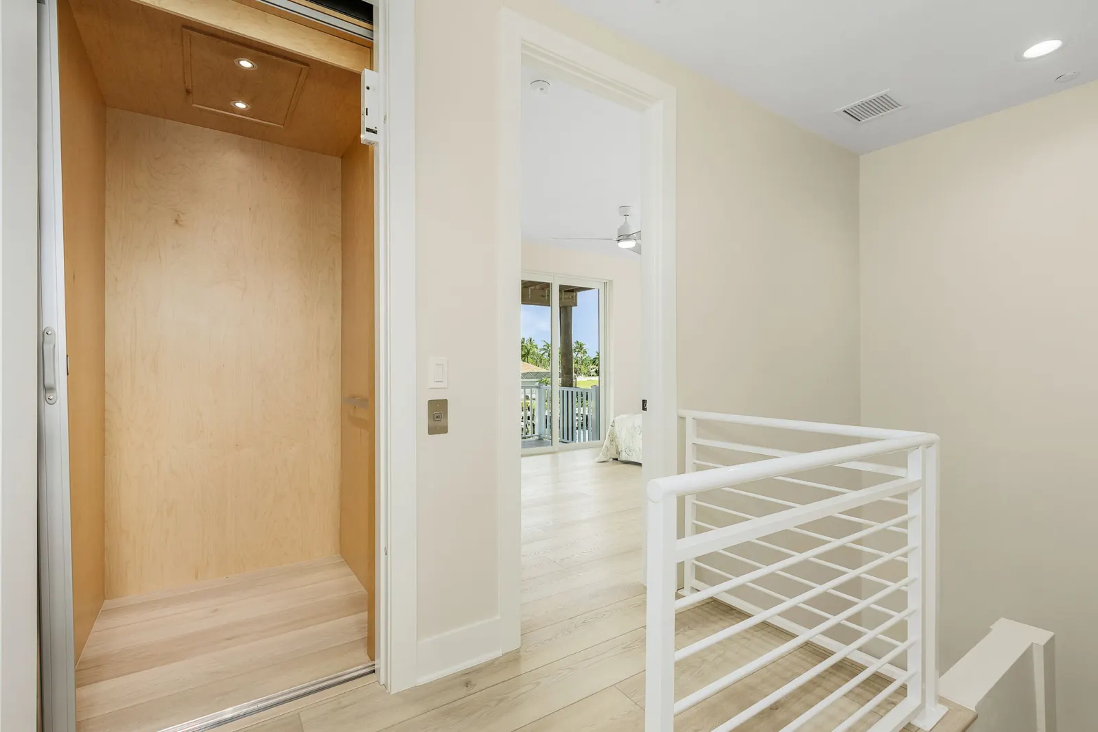 Hallway elevator landing at The Octopus, a custom home built by Marvin Homes in Cape Coral, Florida