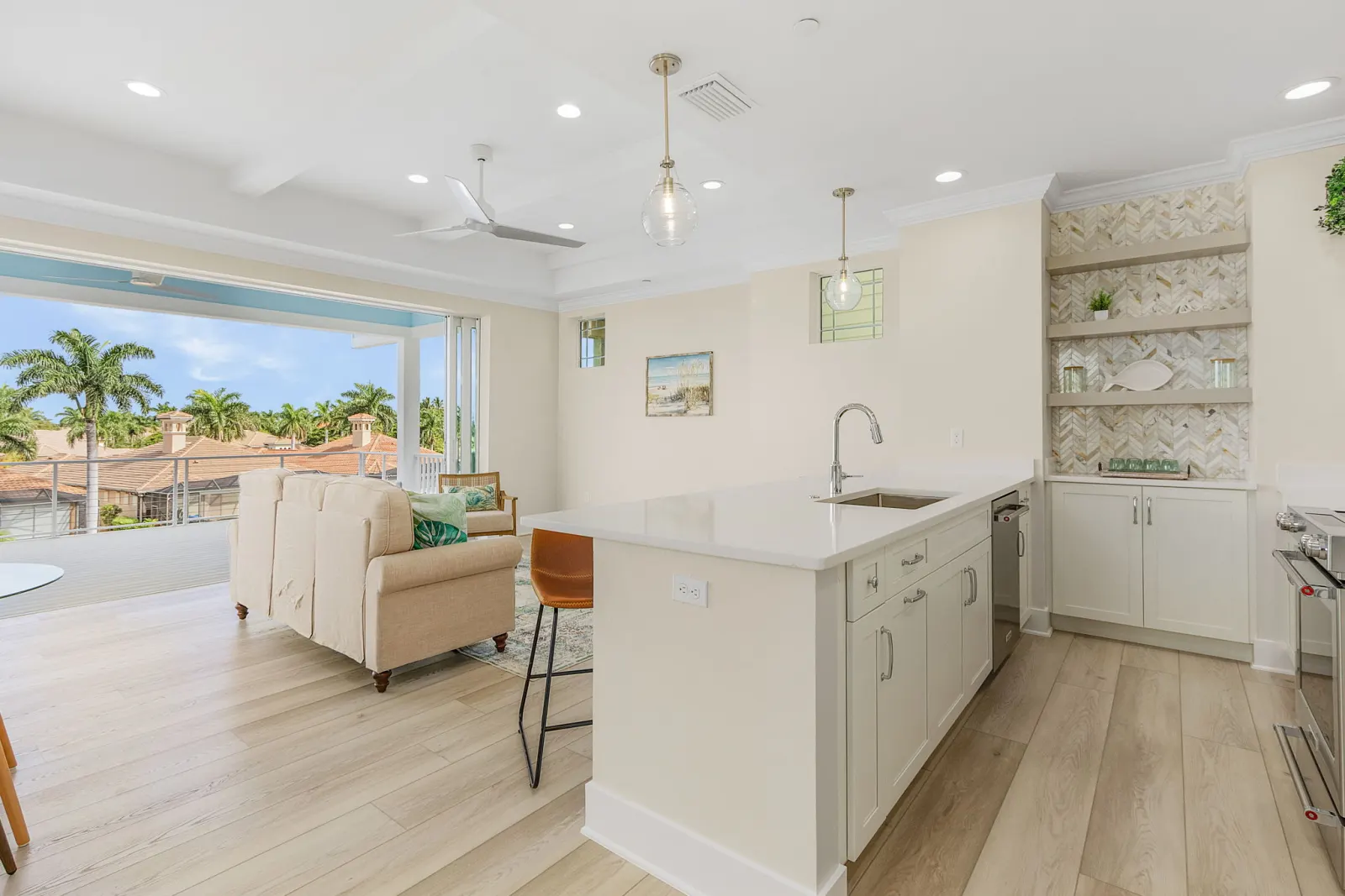Kitchen island open living at The Octopus, a custom home built by Marvin Homes in Cape Coral, Florida