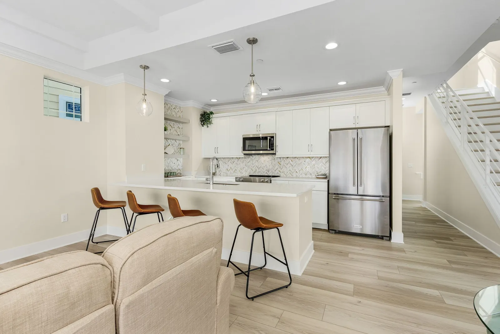 Kitchen range wall stairs at The Octopus, a custom home built by Marvin Homes in Cape Coral, Florida