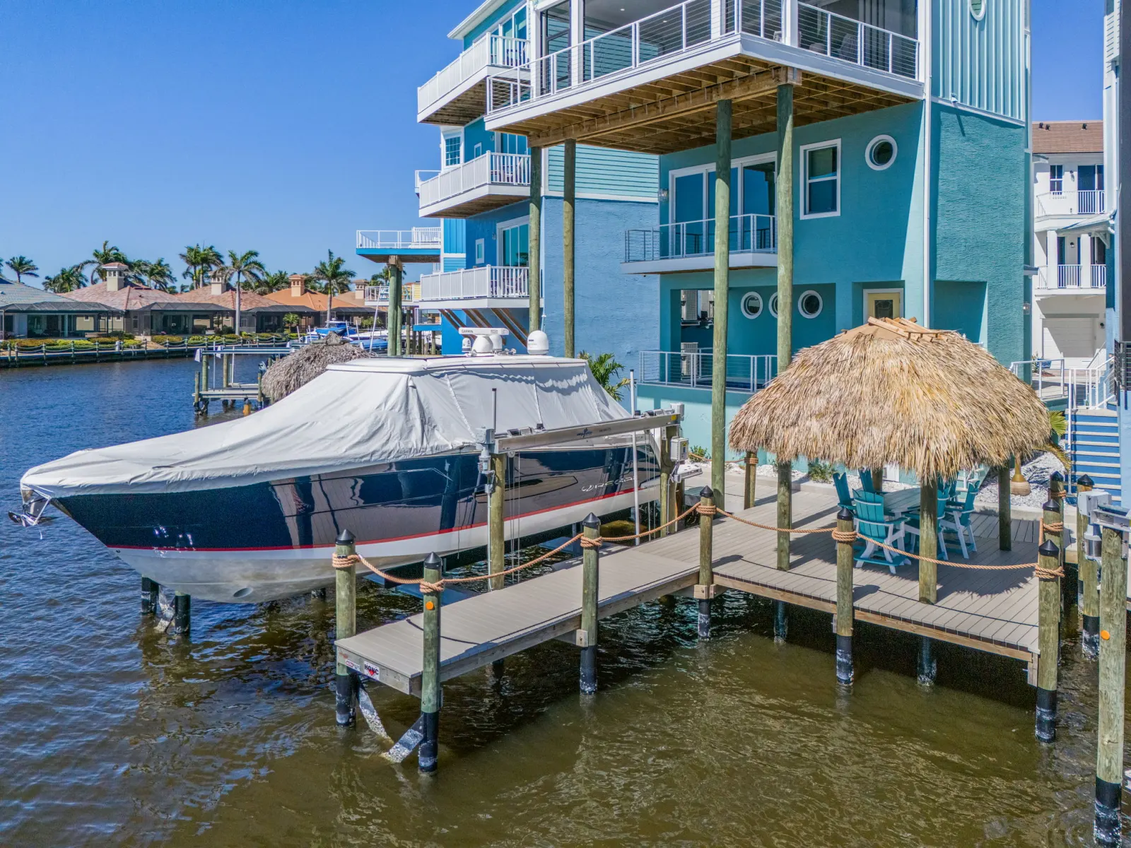 Aerial dock boat tiki hut at Pelican's Perch, a custom home built by Marvin Homes in Cape Coral, Florida