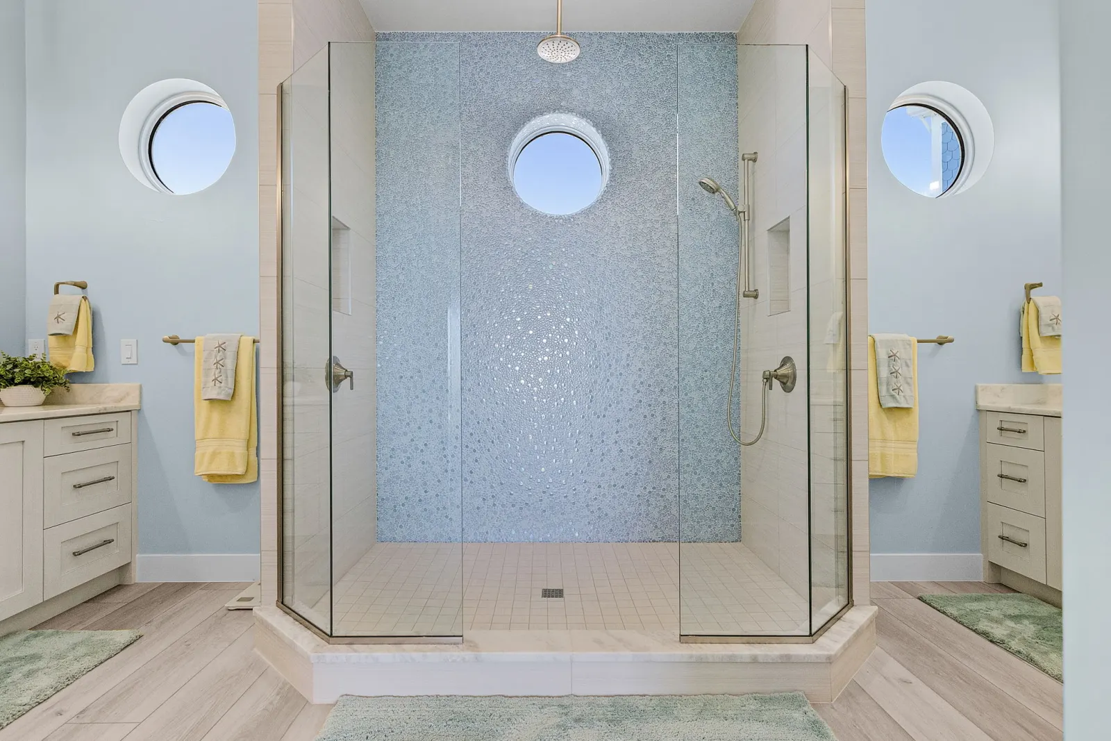 Bathroom dual vanity pebble shower at Pelican's Perch, a custom home built by Marvin Homes in Cape Coral, Florida