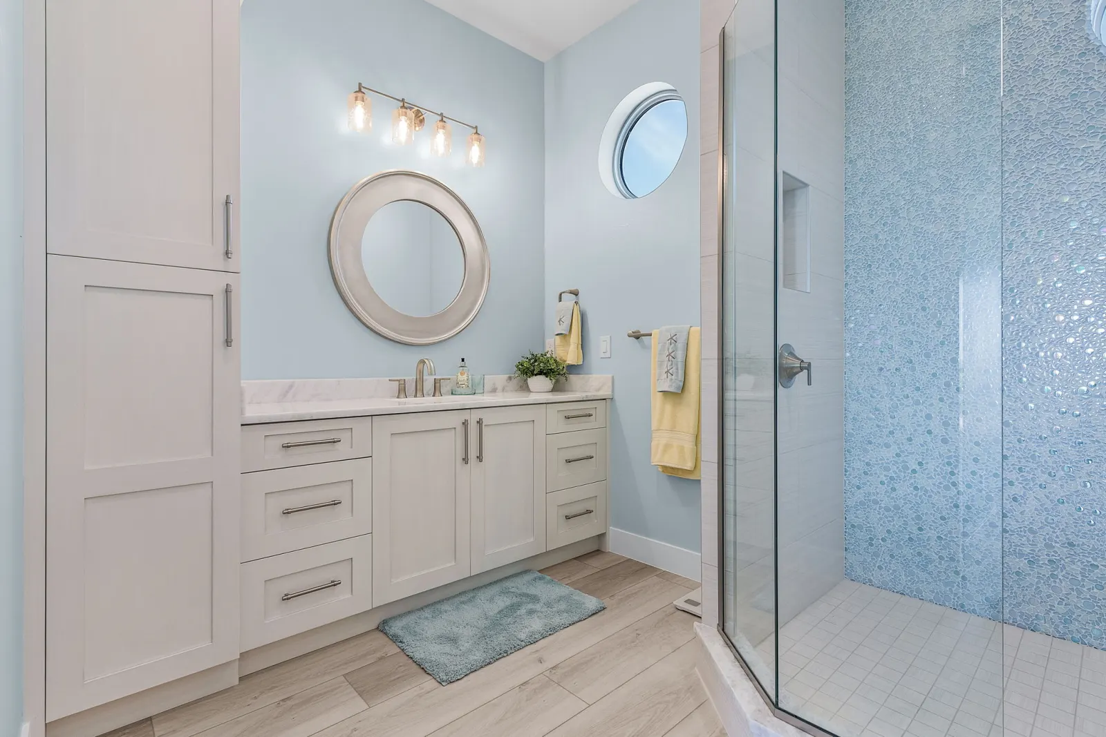 Bathroom vanity porthole window at Pelican's Perch, a custom home built by Marvin Homes in Cape Coral, Florida