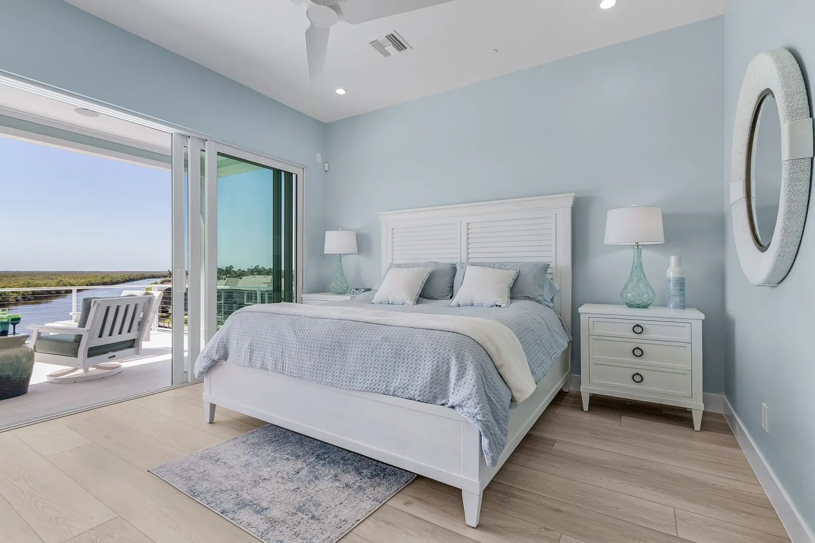 Bedroom primary canal view porch at Pelican's Perch, a custom home built by Marvin Homes in Cape Coral, Florida
