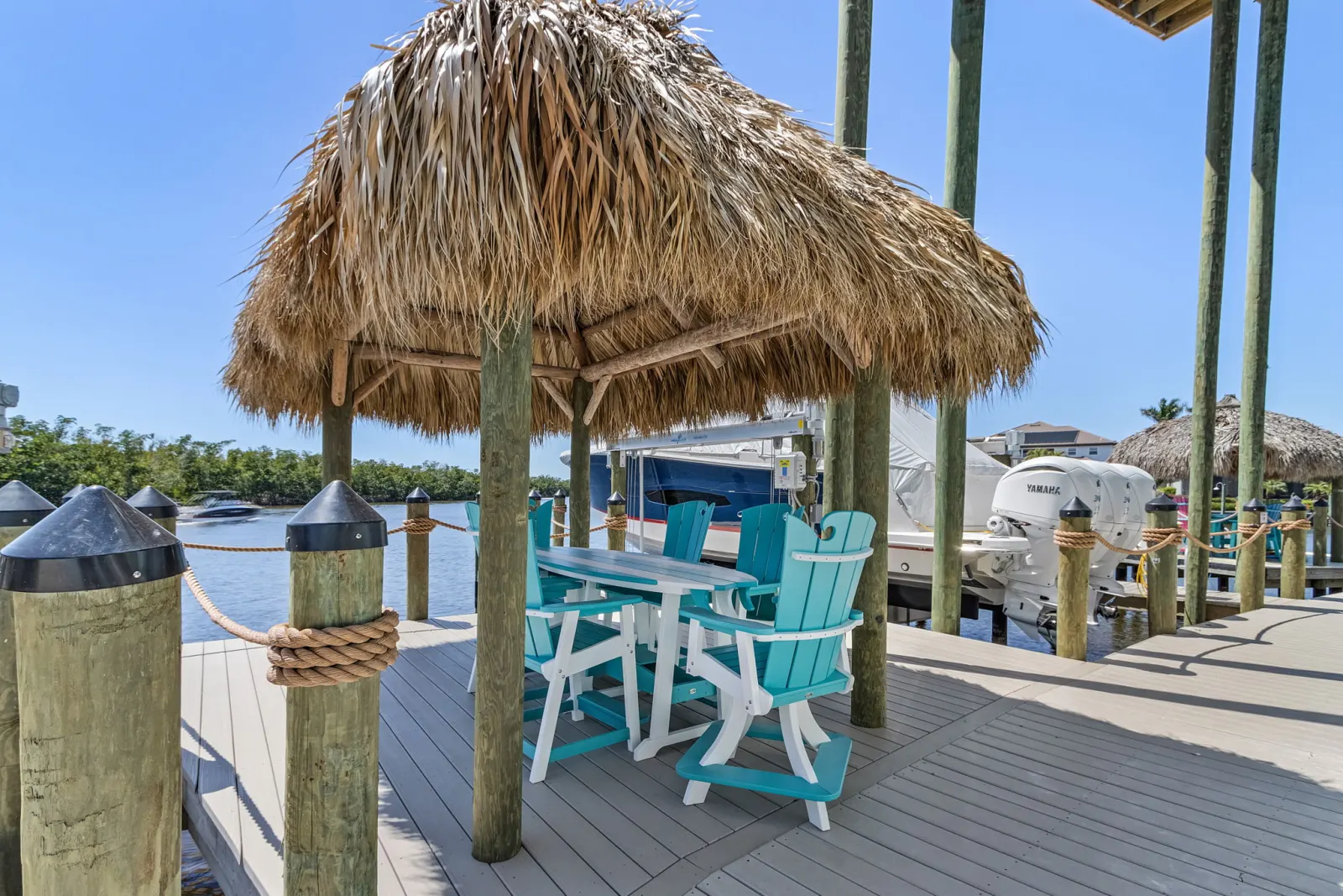 Dock tiki hut seating at Pelican's Perch, a custom home built by Marvin Homes in Cape Coral, Florida