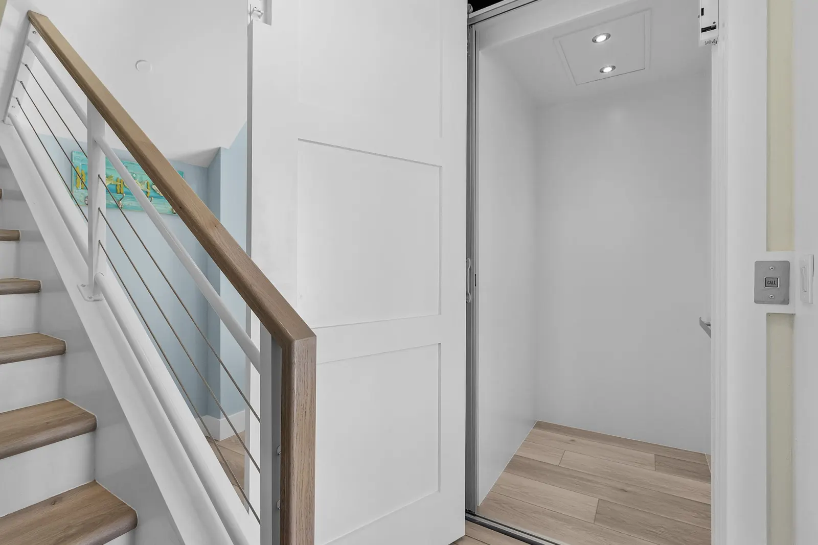 Entry staircase and elevator landing in a completed Marvin Homes custom home