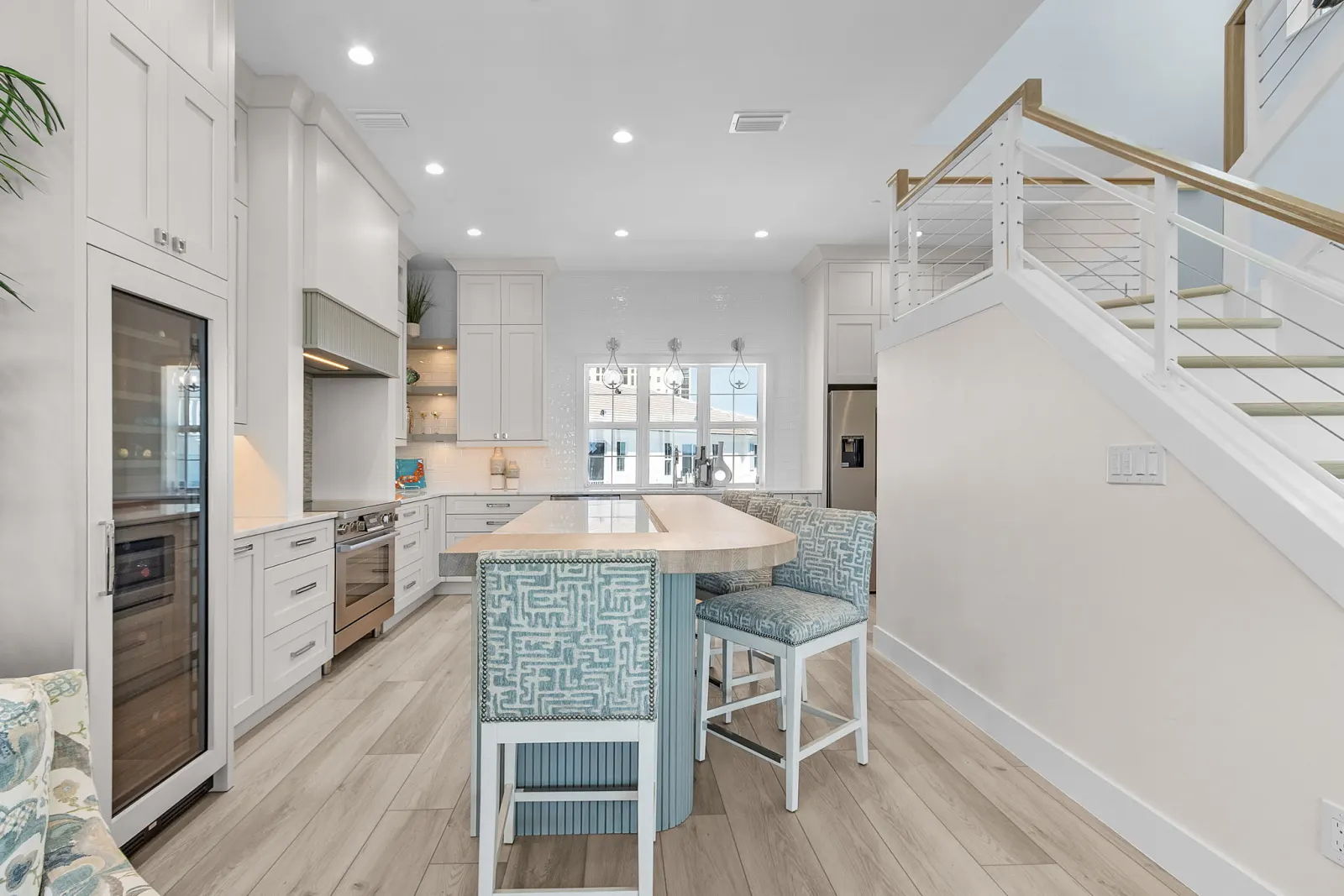 Kitchen island stairs at Pelican's Perch, a custom home built by Marvin Homes in Cape Coral, Florida