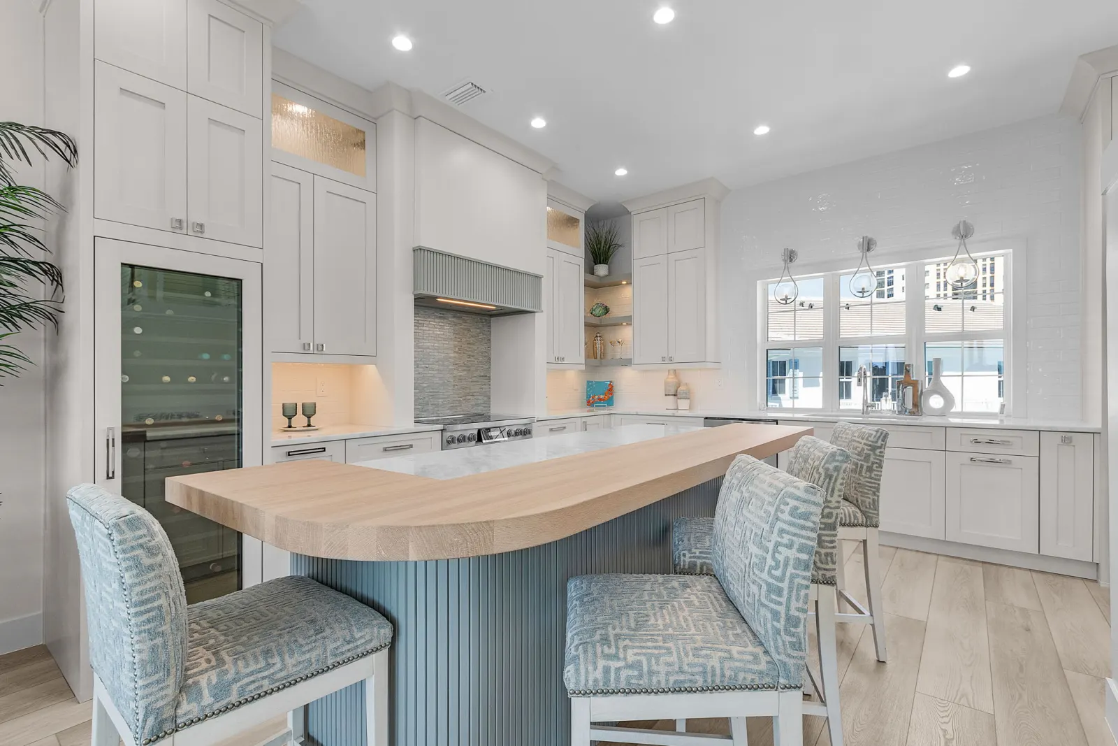 Kitchen range hood wine cooler at Pelican's Perch, a custom home built by Marvin Homes in Cape Coral, Florida