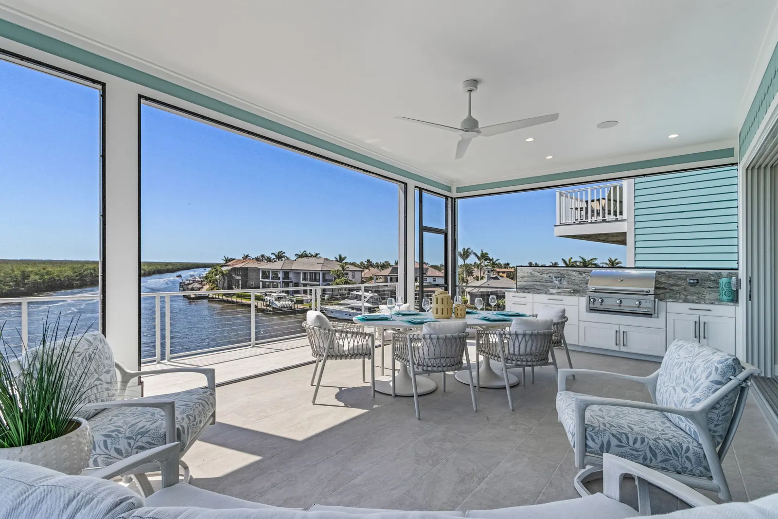 Lanai dining grill canal view at Pelican's Perch, a custom home built by Marvin Homes in Cape Coral, Florida