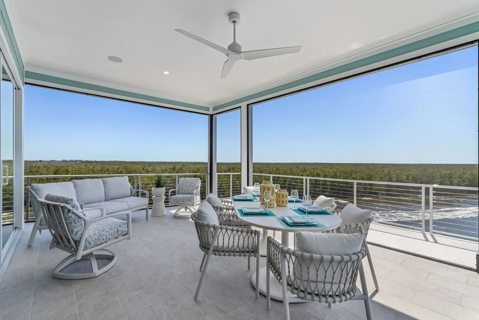 Lanai dining sofa preserve view at Pelican's Perch, a custom home built by Marvin Homes in Cape Coral, Florida
