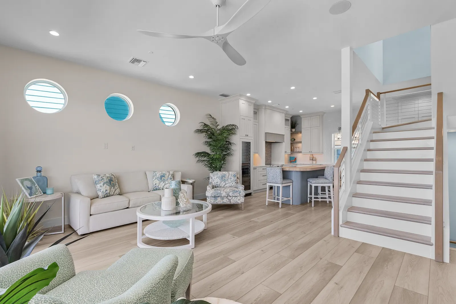 Living room stairs open kitchen at Pelican's Perch, a custom home built by Marvin Homes in Cape Coral, Florida