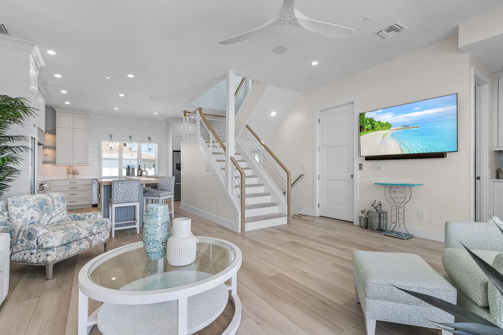 Living room tv wall stairs at Pelican's Perch, a custom home built by Marvin Homes in Cape Coral, Florida
