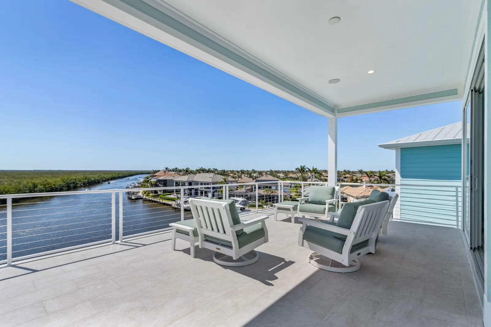 Rooftop deck lounge canal view at Pelican's Perch, a custom home built by Marvin Homes in Cape Coral, Florida
